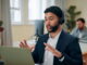 Male sales representative on telephone headset with potential customer.